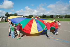 Children enjoying playing with the parachute.